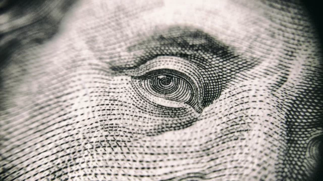 Close-up of a human eye on a banknote, symbolizing the surveillance concerns addressed by the ePrivacy Regulation.