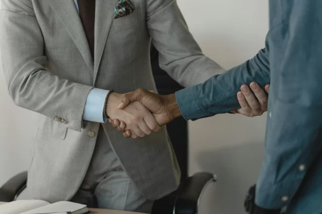 Two professionals shaking hands, symbolizing a partnership focused on ePrivacy Regulation compliance.