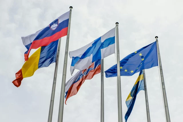 Flags of European nations flying together to represent international cooperation in DLP.