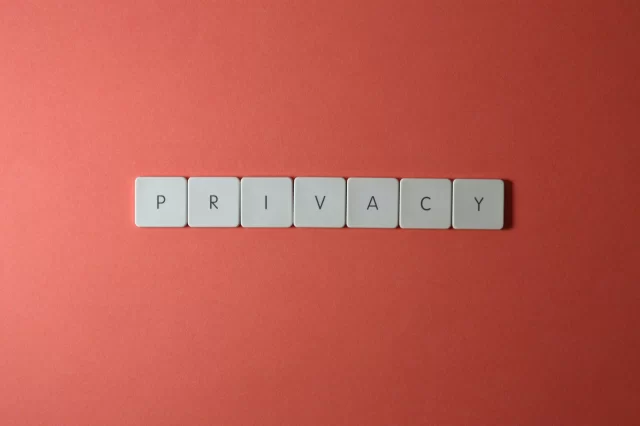 Scrabble tiles on a red background spelling out the word Privacy, representing key concepts in GDPR compliance.
