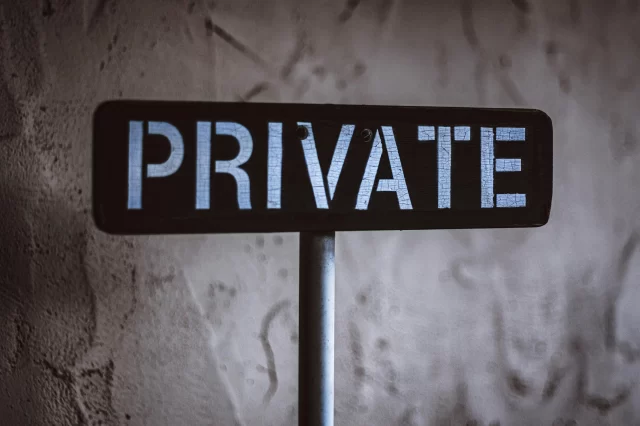 A weathered wooden sign with the word PRIVATE, serving as a symbolic indicator of our company Privacy Policy.