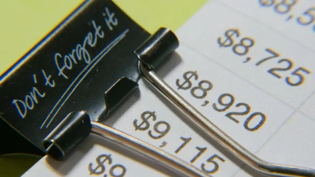Binder clip on a document highlighting price tiers for Swiss cloud offerings.