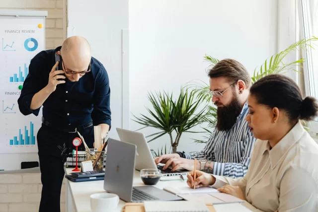 A diverse professional team collaborating in a modern office, analyzing data related to Switzerland's Payment Card Industry.