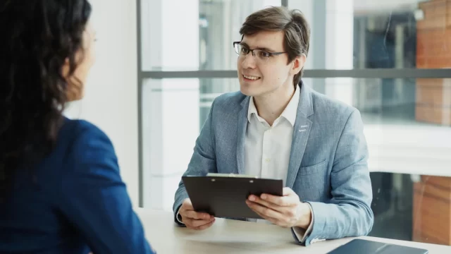 Professional interviewer reviewing documents to help a company comply with Swiss GDPR.