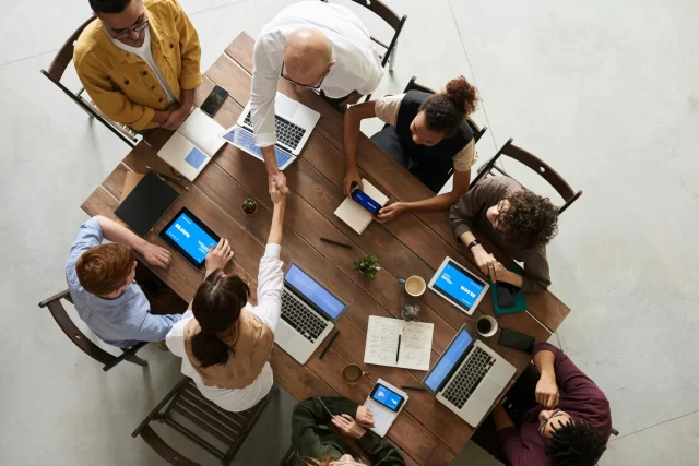 A diverse professional team collaborating around a table to strategize on GDPR Compliance in Switzerland.