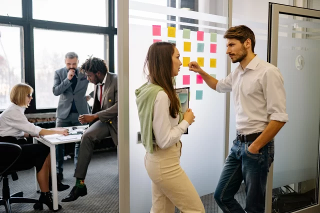 Diverse business team collaborating in an office setting to discuss strategies for GDPR in Switzerland.
