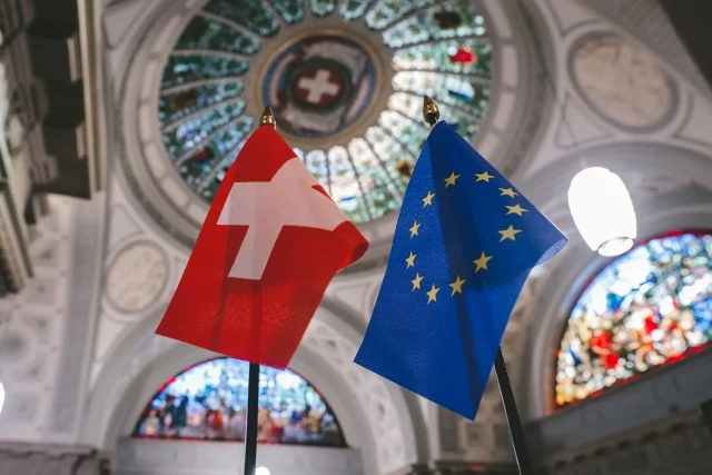 Swiss and European Union flags representing general data protection regulation compliance.